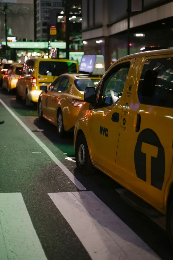 The Art of Drawing Readers In: Your attractive post title goes here Row of modern various yellow taxi vehicles parked on city street near buildings in New York at night
